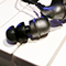 Small, wired in-ear monitors lay on a keyboard.